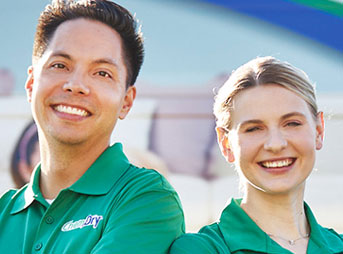 two technicians smiling in front of Chem-Dry van